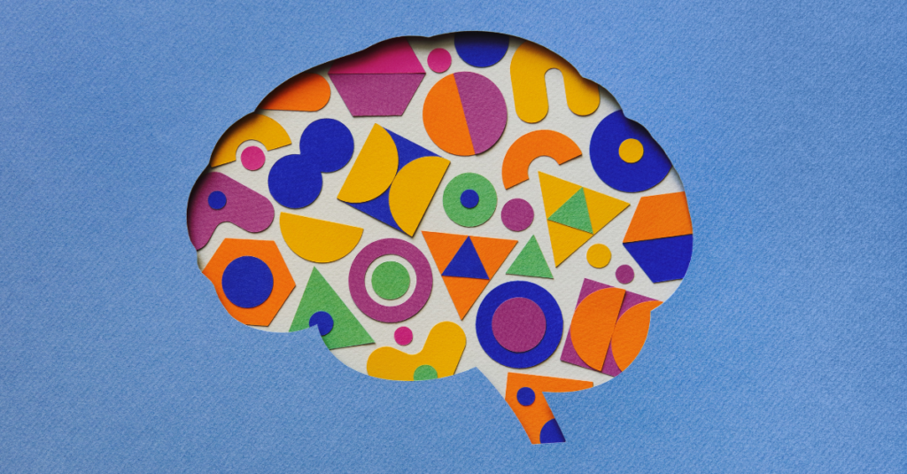 Outline of the human brain with colorful paper chips inside