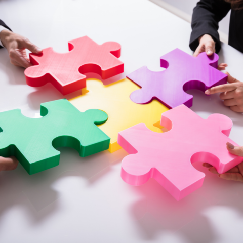 Employees connect colorful puzzle pieces